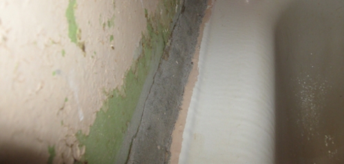 стык между ванной и стеной, замазанный цементом